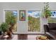 Living room showing views of the outdoors through many windows and hardwood flooring at 11398 Ranch Elsie Rd, Golden, CO 80403