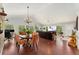 Open-concept living room features hardwood floors, vaulted ceilings, dining area, and floor-to-ceiling windows at 11398 Ranch Elsie Rd, Golden, CO 80403