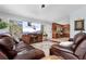 Comfortable living room flowing into a modern kitchen, featuring large windows with scenic views and cozy seating at 11398 Ranch Elsie Rd, Golden, CO 80403