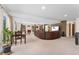 Open concept living area with a modern entertainment center, large windows, and a casual dining space at 11398 Ranch Elsie Rd, Golden, CO 80403