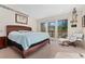 Spacious main bedroom with large windows and seating area with access to deck at 11398 Ranch Elsie Rd, Golden, CO 80403