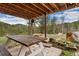 Covered patio with picnic table and a view of the expansive forest at 11398 Ranch Elsie Rd, Golden, CO 80403