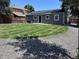 Spacious backyard with lush lawn, new gray siding, and a private gravel area at 1455 S Tennyson St, Denver, CO 80219