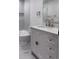 Chic bathroom featuring a modern vanity with stylish hardware and a marble tiled shower at 1455 S Tennyson St, Denver, CO 80219