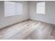 Bright bedroom with modern floors, white walls, and natural light from the large windows at 1455 S Tennyson St, Denver, CO 80219