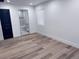 Bedroom with wood flooring leading into a bathroom with marble vanity at 1455 S Tennyson St, Denver, CO 80219