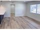 Bright and airy bedroom featuring modern floors, white walls, and an open doorway at 1455 S Tennyson St, Denver, CO 80219