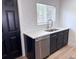 Modern kitchen with stylish fixtures, stainless steel appliances, and herringbone backsplash at 1455 S Tennyson St, Denver, CO 80219