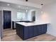 Well-lit kitchen featuring a large island, stainless steel appliances, and wood flooring at 1455 S Tennyson St, Denver, CO 80219