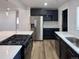 Spacious kitchen with stainless steel appliances, a gas cooktop, and ample counter space at 1455 S Tennyson St, Denver, CO 80219