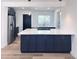 Modern kitchen with stainless steel appliances, island, and stylish pendant lighting at 1455 S Tennyson St, Denver, CO 80219