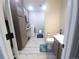 A combined bathroom and laundry room features ample storage cabinets and a modern washer and dryer at 5026 S Danube St, Aurora, CO 80015