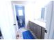 Bright bathroom with a modern vanity, tile floors, and a well-lit adjoining toilet room at 5026 S Danube St, Aurora, CO 80015