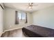 Neutral-toned bedroom features modern ceiling fan, window with views, and sleek, minimalist decor at 5026 S Danube St, Aurora, CO 80015