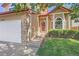 Brick house with a two-car garage and a manicured lawn at 5026 S Danube St, Aurora, CO 80015