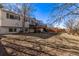Expansive backyard with mature trees and a wooden deck provides ample space for outdoor enjoyment at 2268 S Laredo St, Aurora, CO 80013