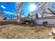 Expansive backyard with lush lawn, deck, and mature trees, perfect for outdoor living at 2268 S Laredo St, Aurora, CO 80013