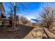 This backyard features a multi-level deck shaded by mature trees, offering a private outdoor retreat at 2268 S Laredo St, Aurora, CO 80013