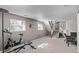 Finished basement with exercise equipment, stairs, and a cozy seating area with a fireplace at 2268 S Laredo St, Aurora, CO 80013
