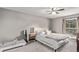 Comfortable bedroom with ceiling fan, neutral walls, and a large window at 2268 S Laredo St, Aurora, CO 80013