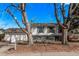 Charming home with a front porch, manicured lawn, and mature trees providing shade at 2268 S Laredo St, Aurora, CO 80013