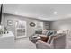 Bright living room featuring large windows and a comfortable sectional couch at 2268 S Laredo St, Aurora, CO 80013