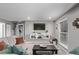 Comfortable living room with floating shelves, a TV, and natural light at 2268 S Laredo St, Aurora, CO 80013