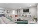 Cozy living room featuring a comfortable sectional sofa, mounted TV, and stylish shelving unit at 2268 S Laredo St, Aurora, CO 80013