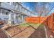 Backyard featuring a lawn, stone-lined garden, patio, privacy fence, and access to the home at 8312 S Saulsbury St # C, Littleton, CO 80128