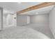 Large basement featuring gray carpeting and exposed beam, perfect for entertaining at 8312 S Saulsbury St # C, Littleton, CO 80128