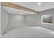 Spacious basement with gray carpeting and exposed wood beam ceiling at 8312 S Saulsbury St # C, Littleton, CO 80128