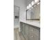 Bathroom features a modern vanity with a framed mirror and a glass-enclosed shower at 8312 S Saulsbury St # C, Littleton, CO 80128
