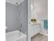 Bathroom featuring gray tiled shower, a white sink with vanity, and wood look floors at 8312 S Saulsbury St # C, Littleton, CO 80128