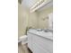 Half bathroom with a toilet, sink and a large mirror at 8312 S Saulsbury St # C, Littleton, CO 80128