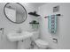 Modern bathroom featuring white pedestal sink, toilet, and decorative floating shelves at 8312 S Saulsbury St # C, Littleton, CO 80128