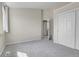 An airy bedroom with neutral walls, plush carpeting, and a double door closet at 8312 S Saulsbury St # C, Littleton, CO 80128