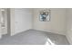Bright bedroom featuring gray carpeting and a closet with white doors at 8312 S Saulsbury St # C, Littleton, CO 80128