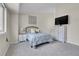 Cozy bedroom features neutral tones, soft carpet, and a large window for natural light at 8312 S Saulsbury St # C, Littleton, CO 80128