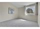 This empty bedroom offers soft carpet, natural light, and a blank canvas for design at 8312 S Saulsbury St # C, Littleton, CO 80128