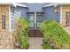 Close-up of townhome entrances with stone accents and manicured landscaping at 8312 S Saulsbury St # C, Littleton, CO 80128