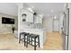 Open kitchen with stainless steel appliances, breakfast bar, and hardwood floors for a modern living experience at 8312 S Saulsbury St # C, Littleton, CO 80128