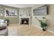 Inviting living area featuring a fireplace, light-filled ambiance, and a mounted television at 8312 S Saulsbury St # C, Littleton, CO 80128
