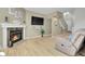 Open-concept living room with hardwood flooring, fireplace, and modern decor at 8312 S Saulsbury St # C, Littleton, CO 80128