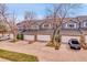 Street-level view of townhomes featuring garages, manicured lawns, and tasteful exteriors at 8312 S Saulsbury St # C, Littleton, CO 80128