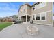 Spacious backyard featuring a concrete patio, a fire pit, and a hot tub at 3014 Furthermore Ln, Castle Rock, CO 80108