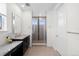 Bathroom with stone countertop, glass enclosed shower, and white cabinets provides an elegant and functional design at 3014 Furthermore Ln, Castle Rock, CO 80108