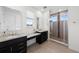 The main bathroom features double sinks, granite countertops and a glass enclosed shower at 3014 Furthermore Ln, Castle Rock, CO 80108