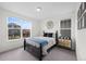 Cozy bedroom with a large window, neutral colors, and simple decor for a peaceful atmosphere at 3014 Furthermore Ln, Castle Rock, CO 80108