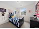 Bright bedroom featuring carpet, baseball decor, and a single window for natural light at 3014 Furthermore Ln, Castle Rock, CO 80108