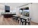 Bright dining room features a large table, wood floors, and sliding doors leading to an outdoor area at 3014 Furthermore Ln, Castle Rock, CO 80108